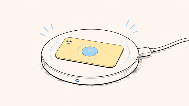 A card tracker resting on a wireless charging pad