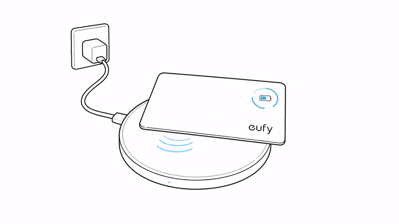 eufy SmartTrack Card E40 recharging wirelessly on a Qi charging pad with battery indicator