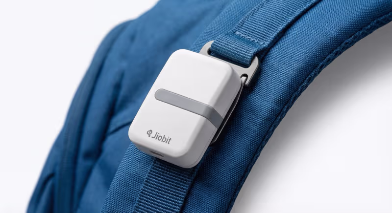 Jiobit Gen 3 clipped to a child's backpack strap for discreet tracking