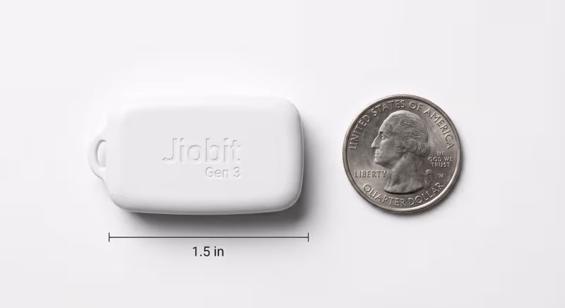 Jiobit Gen 3 size comparison next to a coin showing its compact dimensions